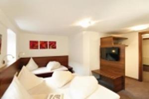 a hotel room with a bed and a television at Ischgl Suite in Ischgl