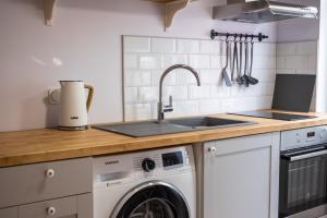 a kitchen with a sink and a washing machine at Dream Stay - Authentic Studio near Seaplane Harbour in Tallinn