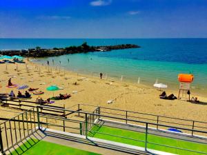 a beach with people on the sand and the ocean at Boutique Hotel Royal in Nesebar