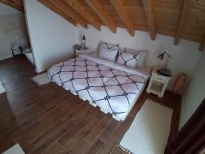 a bedroom with a bed and a wooden floor at Captain's Attic in Račišće