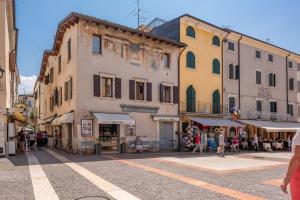 a group of buildings on a street with people walking at Ca'Dinora - Caesar apartment in Bardolino