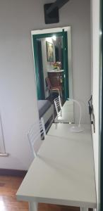 a white bench in a room with a mirror at Hotel Sporting in Campagnola Emilia +22 photos