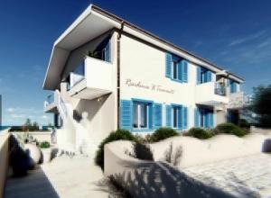 wykonanie białego budynku z niebieskimi oknami w obiekcie Apartment Tramonto sea-front w mieście Valledoria