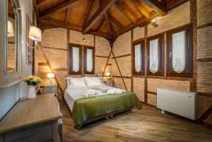 a bedroom with a bed in a room with wooden ceilings at Fairytale Villa in Lefkada Town
