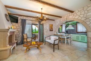 a living room with a fireplace and a table at Fairytale Villa in Lefkada Town