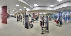 a gym with treadmills and machines in a building at Grand Hotel Vidgof in Chelyabinsk
