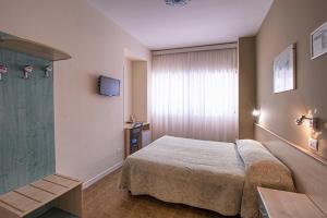 Rúm í herbergi á Hotel Scacciapensieri