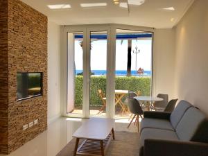 ニースにあるSea View- Easy Home Bookingのリビングルーム(ソファ付)が備わり、海の景色を望めます。