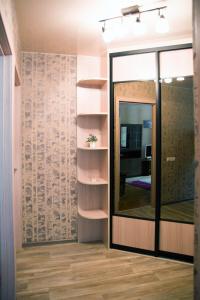 a room with a mirror and a wall with shelves at Уютная, благоустроенная 2-комнатная квартира, WiFi in Bobruisk