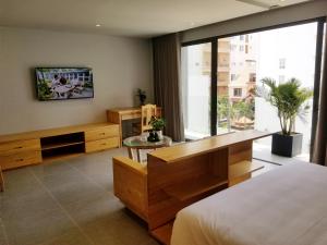 a bedroom with a bed and a large window at Infinity Pool - 5 min walk to beach - Sekong Apartment in Da Nang