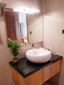 a bathroom with a sink and a mirror at Infinity Pool - 5 min walk to beach - Sekong Apartment in Da Nang +14 photos