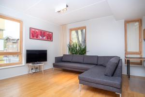 a living room with a couch and a tv at Dream Stay - Stylish Apartment near Old Town with Free Parking in Tallinn