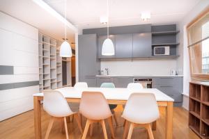 a kitchen and dining room with a table and chairs at Dream Stay - Stylish Apartment near Old Town with Free Parking in Tallinn