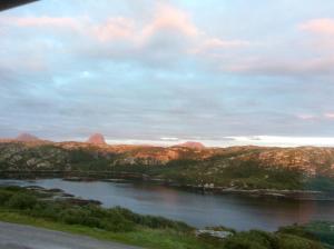 a view of a river with mountains in the background at Achmelvich View self catering in Lochinver