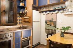 a small kitchen with a table and a refrigerator at House Erofili in Chania