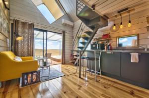 a kitchen and living room in a tiny house at Chambre d'hôtes de charme à la Maison Bleue in Savignac-Mona