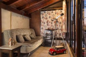 a living room with a couch and a toy car at House Erofili in Chania +1 photo