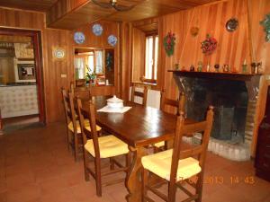 a dining room with a table and chairs and a fireplace at B&B La Pilastrina in Maranello