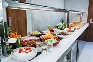 a buffet line with many different types of food at Elysia Park in Paphos