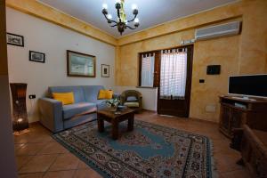 a living room with a couch and a table at Il Borgo sul Lago in Pizzo