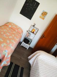 a bedroom with a bed and a bed and a chair at La Casa di Miele in Perugia +1 photo