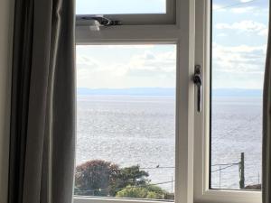 a window with a view of the ocean at The Nook @ Drop Anchor in Portishead