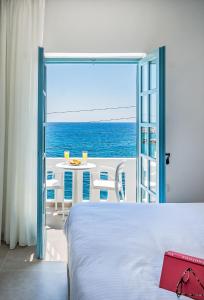 a bedroom with a bed and a view of the ocean at Livikon by the Sea in Hora Sfakion