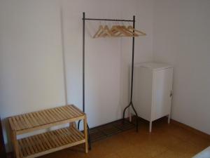 
a room with a wooden floor and a white refrigerator at Quinta da Norinha in Portimão
