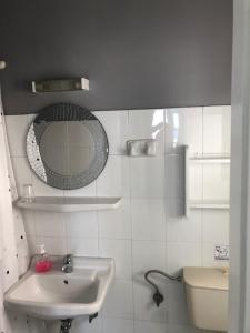 a bathroom with a sink and a mirror and a toilet at Sigma Studios on The Beach in Naxos Chora