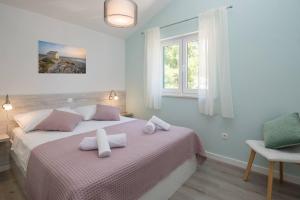 Кровать или кровати в номере Apartments Silvana