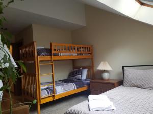 a bedroom with two bunk beds and a bed at Ski In/Out Trailside Townhome in Killington