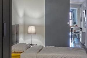 a bedroom with a bed and a table with a lamp at San Giorgio 2 in Bologna