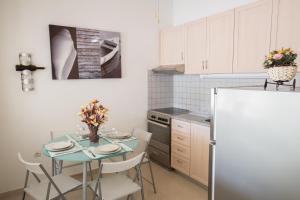 a kitchen with a table and a refrigerator at Casa de Campo 1 in Almyrida