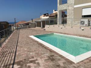 a swimming pool on the side of a house at Residenza Kalios in Tropea