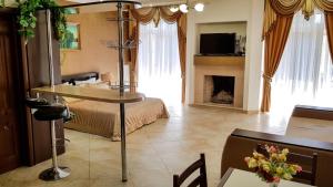 a living room with a bed and a table with a fireplace at мини-отель Травертин in Chornomorsk