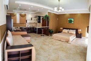 a large room with a bed and a kitchen at мини-отель Травертин in Chornomorsk