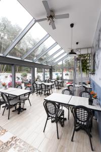 a restaurant with tables and chairs and windows at Rafa przy Plaży in Sztutowo