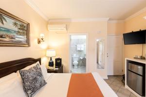 Un pat sau paturi într-o cameră la Bay Gardens Hotel
