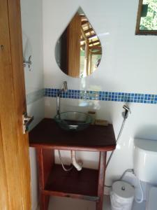a bathroom with a sink and a mirror at Chalé Astral in Alto Paraíso de Goiás