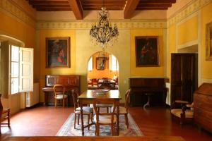 a dining room with a table and chairs at Fattoria La Gigliola in Montespertoli