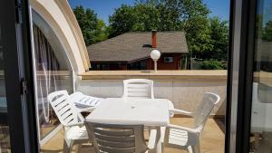 a white table and chairs on a balcony at мини-отель Травертин in Chornomorsk