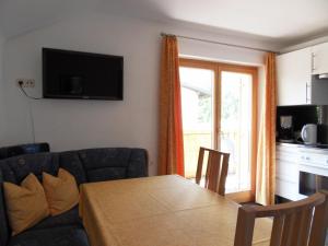 a living room with a table and a couch at Ferienwohnung Konrad Pfeifer in Schruns-Tschagguns