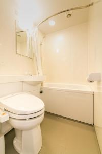 uma casa de banho branca com um WC e uma banheira em Pearl Hotel Kayabacho em Tóquio