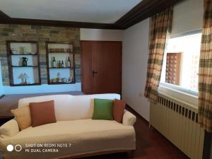 a living room with a couch and a bed at Sunset Beach House in Kato Alepochori