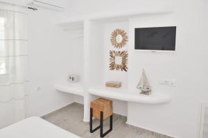 a white bathroom with a sink and a mirror at Villa Erato Naxian album with private pool in Naxos in Glinado Naxos