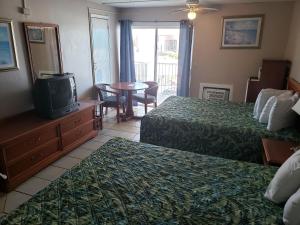 En eller flere senger på et rom på SeaScape Inn - Daytona Beach Shores