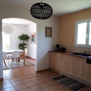 a kitchen with a table and a dining room at Maison de vacances près de Marciac in Troncens