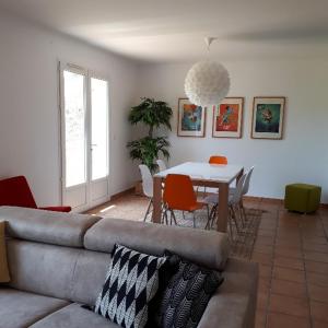 a living room with a couch and a table at Maison de vacances près de Marciac in Troncens