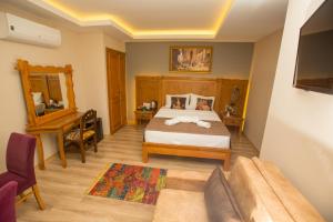 Postel nebo postele na pokoji v ubytování The PeraPort Hotel