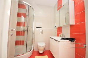 a bathroom with a shower and a toilet and a sink at Apartment Josip 2 in Tribunj +41 photos